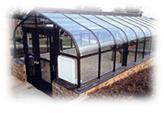 Grand Hideaway Greenhouse-Glass Greenhouses and Triple Wall 8mm Polycarbonate Covering Available.it is beautifiul greenhouses.